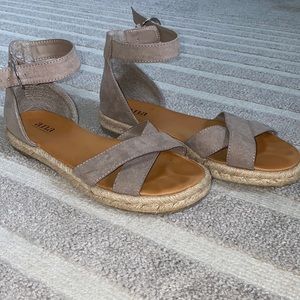 Taupe cross strap sandals with ankle strap.